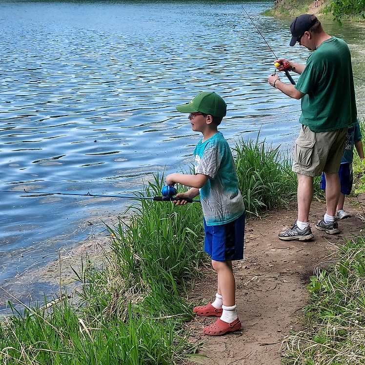 Kids fishing from shore at lake